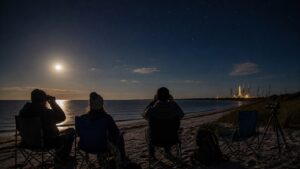 Moonlit coastal launch viewers watching the Artemis program unfold