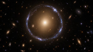 Scientific artist impression of a foreground elliptical galaxy bending a distant blue galaxy into a thin curved Einstein ring.
